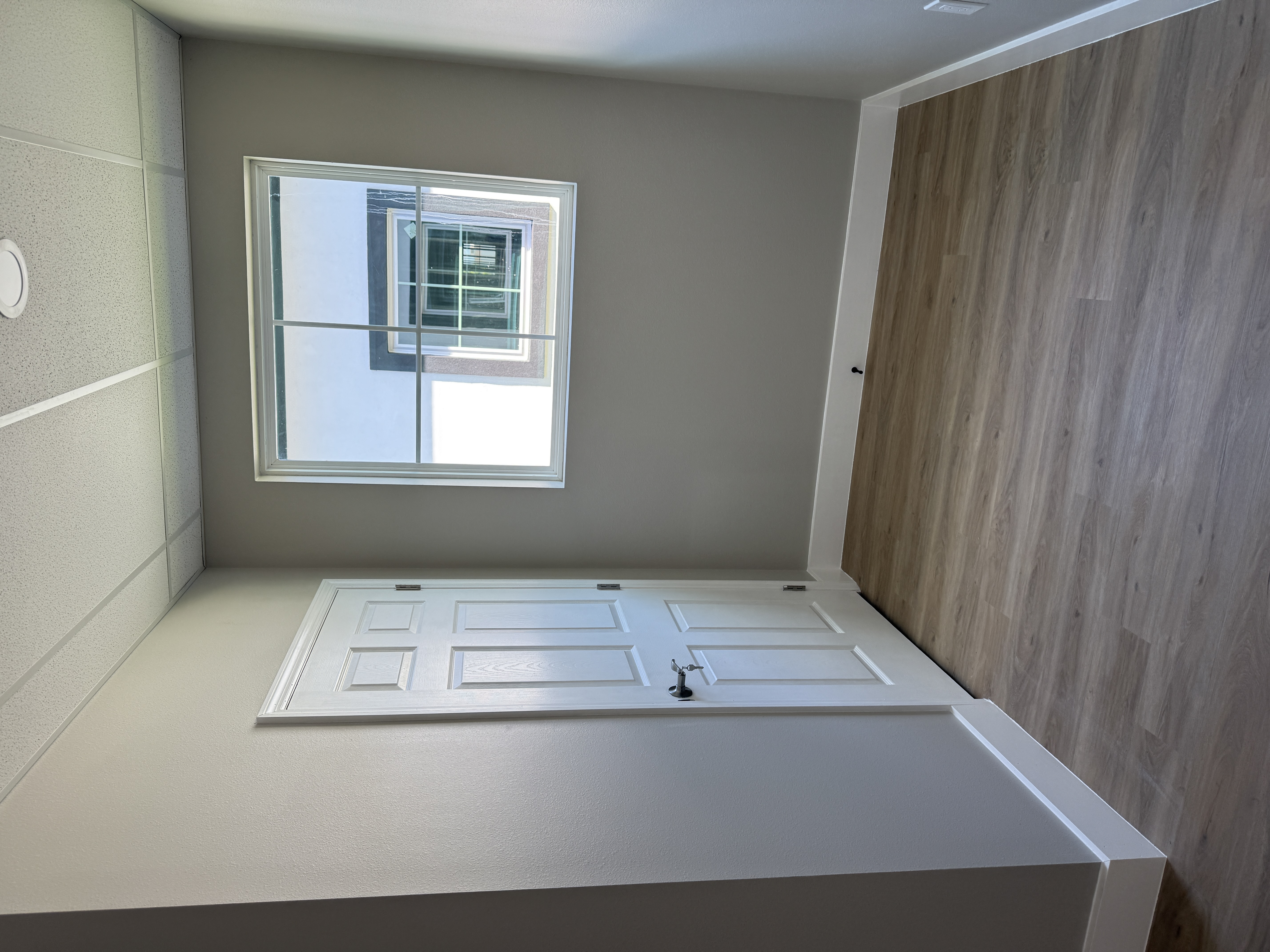 Interior door and trim installed in custom home bedroom