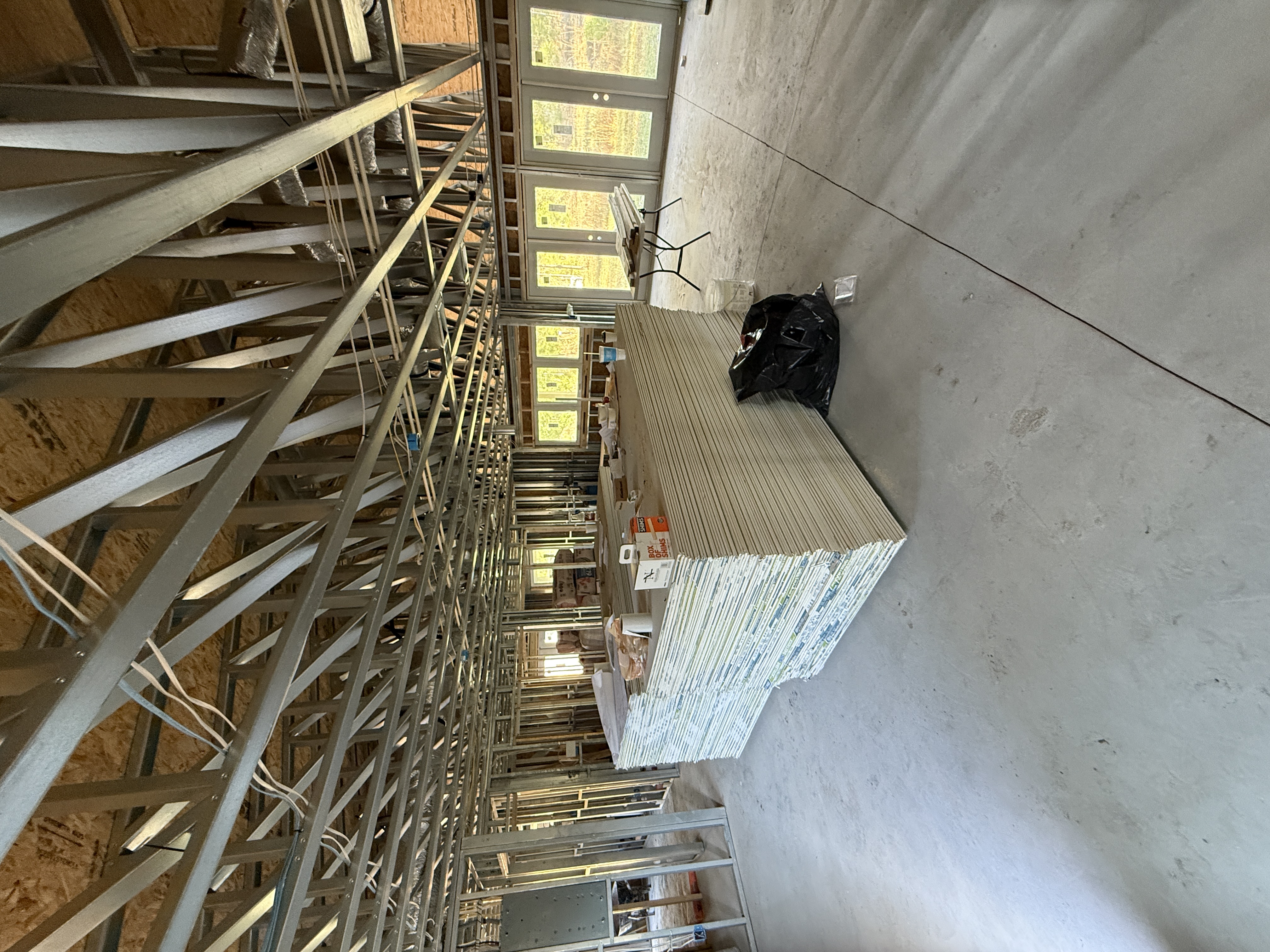 Insulation being installed in steel-framed interior walls