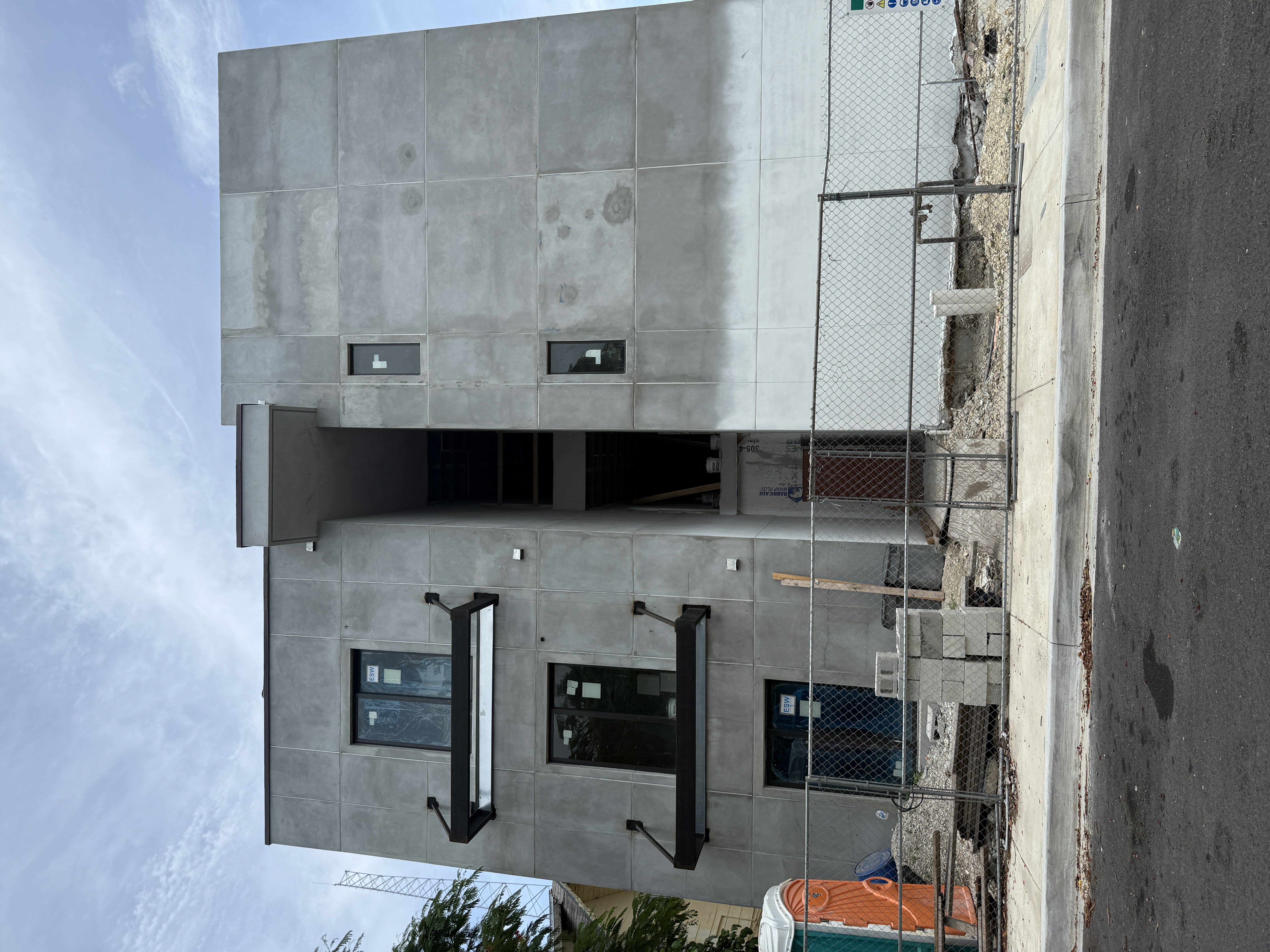Impact windows installed on two-story concrete block home