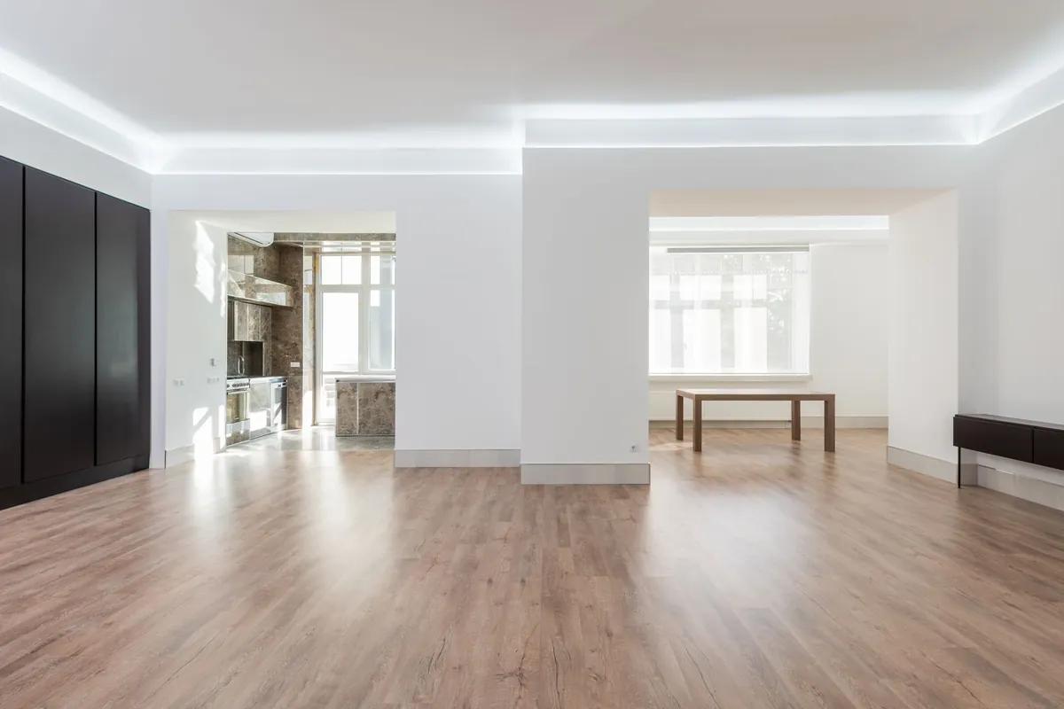 Wood look plank floor across a bright, empty room