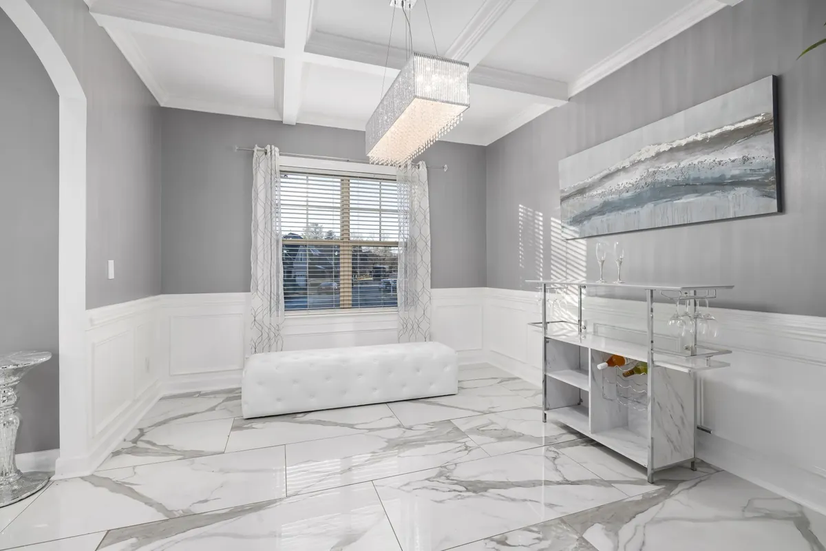 Large glossy white floor tiles with gray veining in a formal room